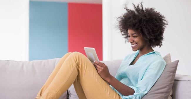 22 CX Stats for 2022 Happy young woman works on tablet at home