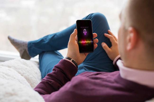Man using virtual assistant on smartphone