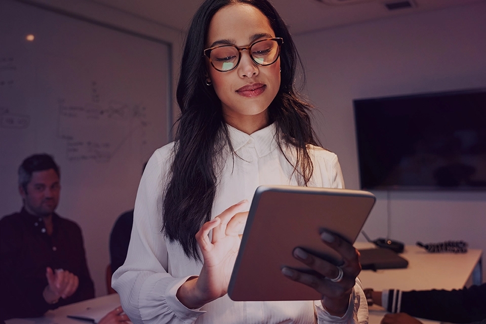 A professional woman working on a tablet